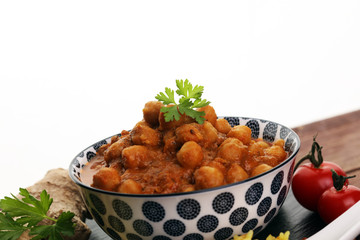 Chana Masala indian dish spicy Chick Peas also known as Chola Masala or Chole served in a white bowl