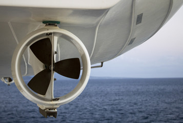 life boat propeller suspended with ocean in background