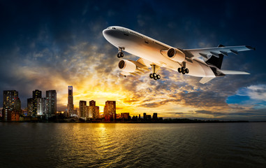 Naklejka na ściany i meble Airplane over river and city