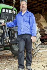 Farmer standing in front of his tractor