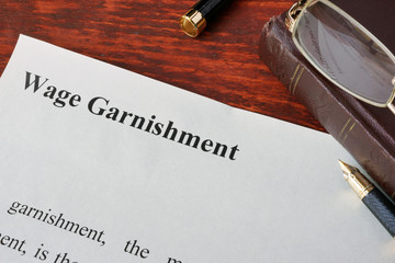 Wage Garnishment definition written on a paper.