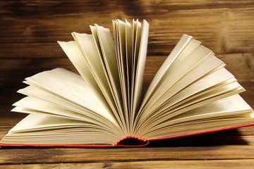 Open book on wooden background