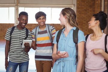 Students interacting while using mobile phone