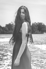 beautiful long-haired woman standing in the river