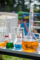 chemical glassware with colorful liquids (open air lab)