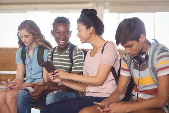 Students using mobile phone in campus - Powered by Adobe