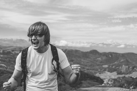 happy man shouting at the mountain top