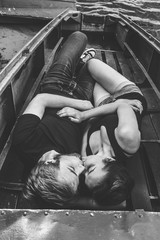 Fototapeta na wymiar happy loving couple lying in the boat