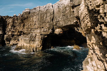 cave in a rock ashore ocean