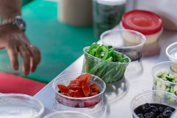Cups full of vegetables as condiments or toppings