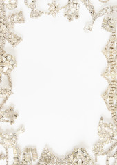 Woman's Jewellery. Frame with old vintage jewelry. Beautiful clear rhinestone necklace and earrings on white. Flat lay, top view