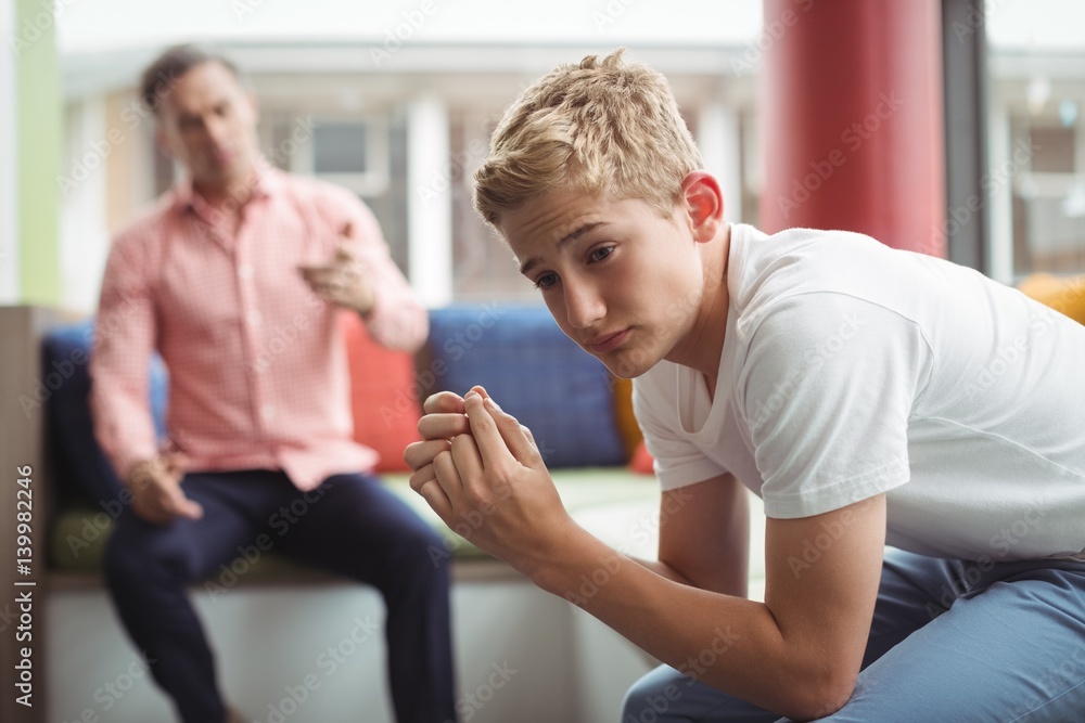 Wall mural teacher scolding student in library