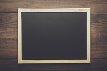 clean blackboard on the wooden table background
