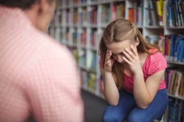 Teacher scolding student in library