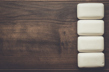 some soap bars on the wooden table background