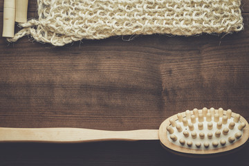 wooden massager brush and bound bast on the brown table
