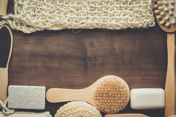 some bath accessories on the brown wooden background