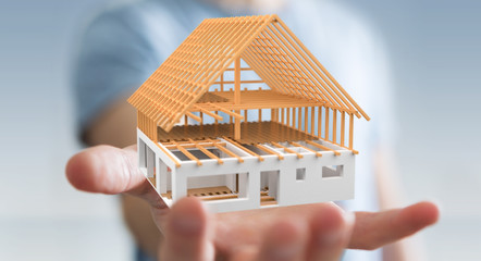 Businessman holding 3D rendering unfinished plan house in his hand