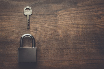 Fototapeta premium check-lock and key on the brown wooden table background