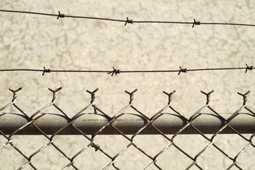 barbed wire fence on concrete background