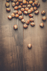 hazelnuts on the brown wooden table background