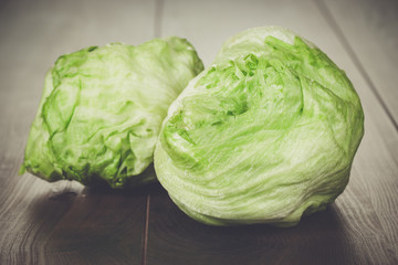 Fototapeta premium fresh green iceberg salad on wooden table
