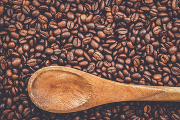 coffee beans and wooden spoon on the table background