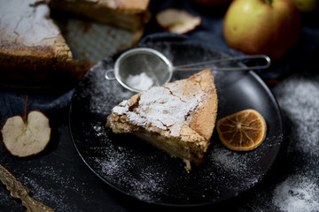 Homemade apple pie. Apple pie tart, ingredients - apples and cinnamon on rustic wooden background