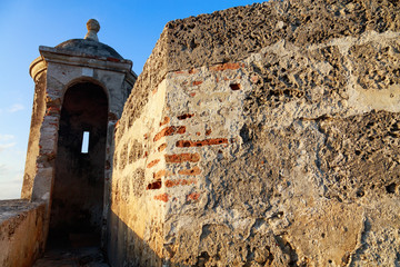The Caribbean tropical sunset hits the colonial wall of Cartagena, Colombia.