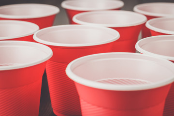 disposable red plastic cups on the wooden table
