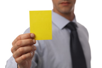 Close up of Businessman showing yellow card. Business and finance concept. Last warning before...