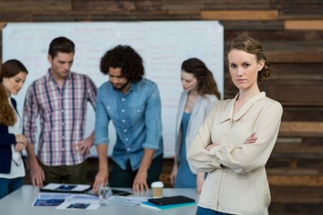 Businesswoman standing with arms crossed
