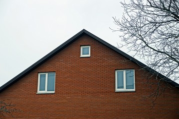 Фасад здания с кирпичной стеной и окнами