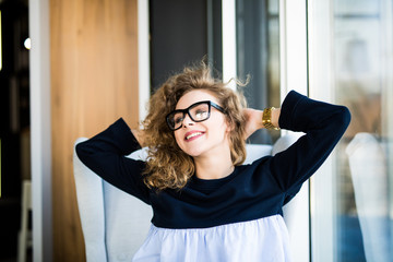 Business woman relaxing working at office desk laid back resting on chair with hands behind head...
