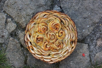 apple tart with roses made of apples , outside sunny weather