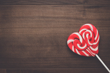 red sugar lollipop on the wooden table