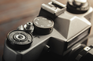 Fototapeta na wymiar Vintage film camera on wooden table. Close up.