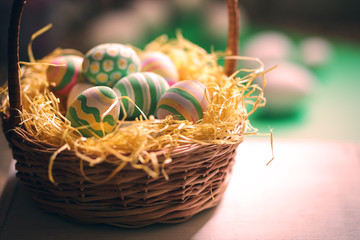 Basket with colorful Easter eggs, close up photo