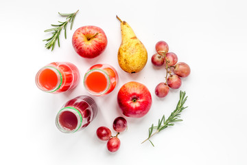 plastic bottles with fruit drinks on white background top view