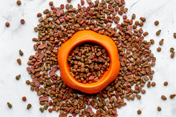 dry dog food in bowl on white background top view