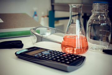 Scientific pocket calculator and test tube