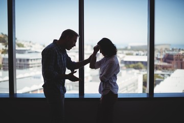 Fototapeta premium Couple arguing near the window