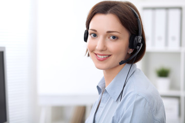  Young beautiful business woman in headset. Call center.