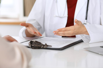 Close up of a doctor and patient hands while discussing medical records after health  examination