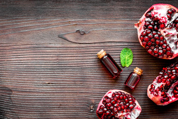 sliced pomegranate on wooden background top view