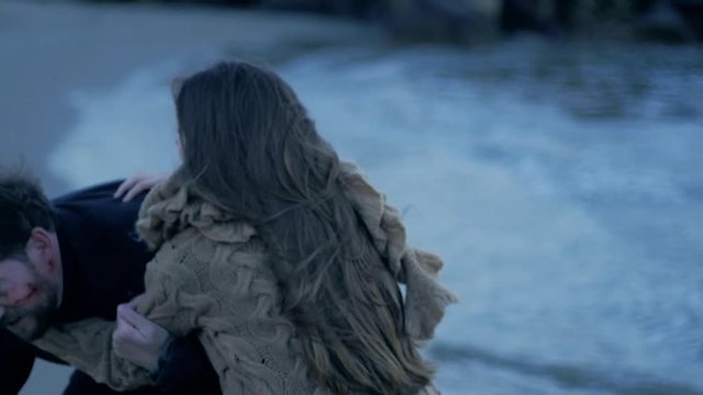 Female vampire jumping on man biting him on neck slow motion