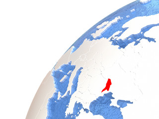 Moldova on metallic globe with blue oceans