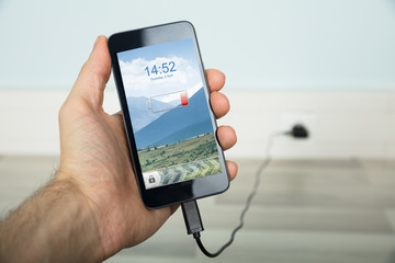 Person Charging His Mobilephone