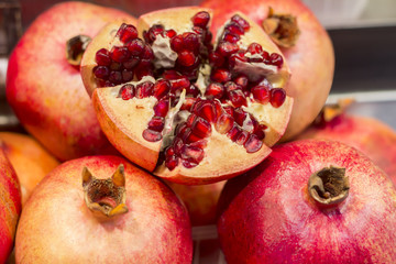 Ripe Juicy pomegranates on market close up