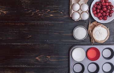 Ingredients for muffin on a dark background